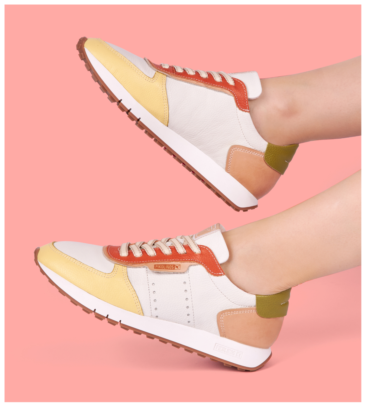Women's creamy sneakers on a pink background